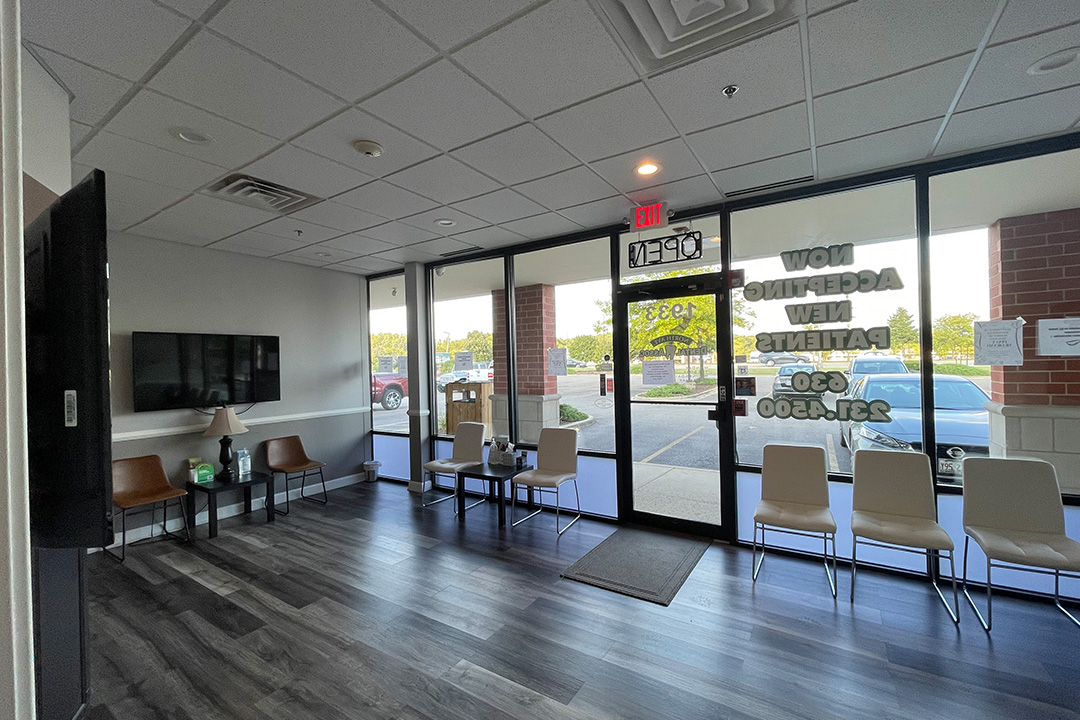 The image shows a well-lit, modern waiting room with a clean and organized interior.