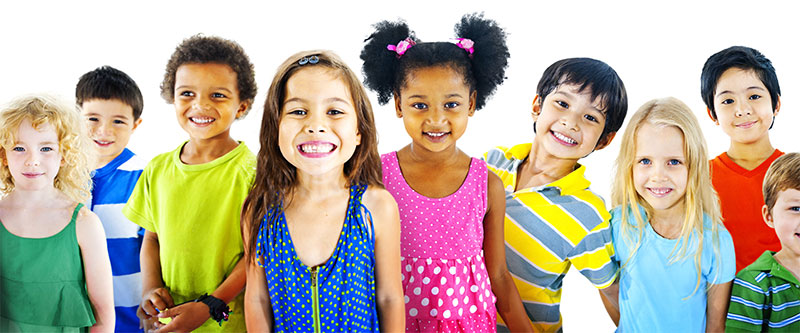 A diverse group of children posing together in a colorful, outdoor setting.