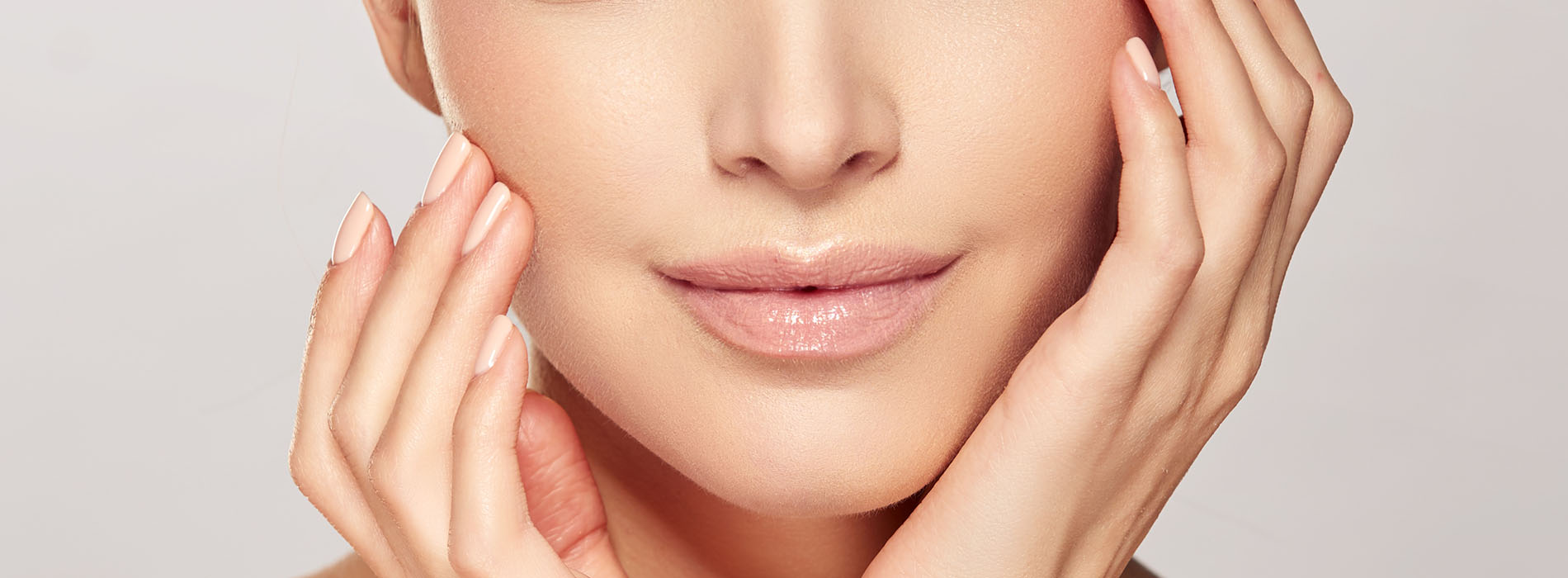 Close-up of a woman s face with a focus on her eyes and the application of what appears to be skincare or makeup product.